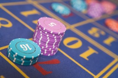 Live Sic Bo table with three dice in sealed shaker and betting layout on screen